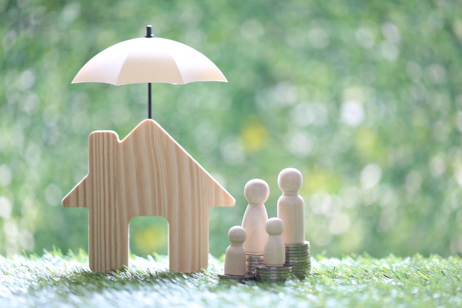 Protection,Model family on stack of coins money with model house